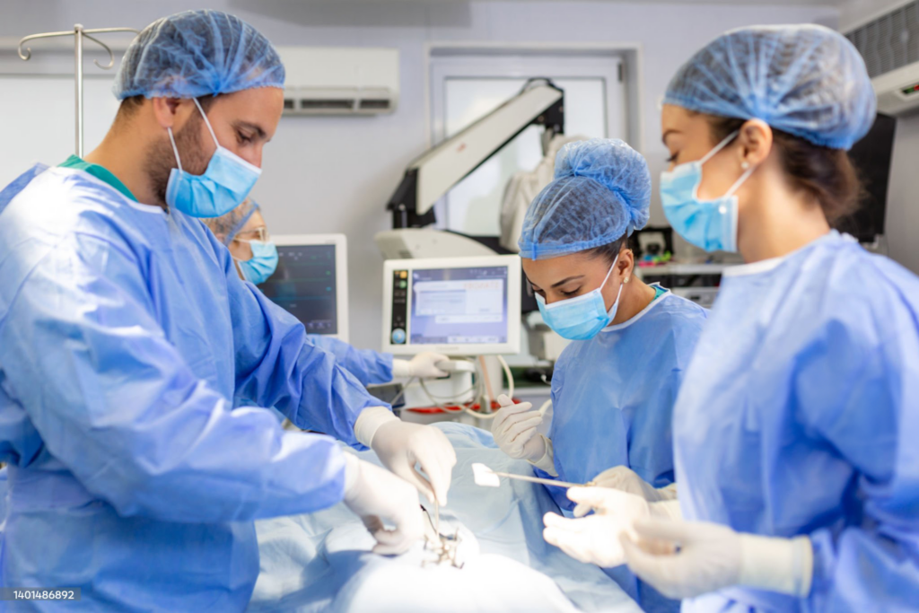 Surgeons performing operation in hospital theatre.