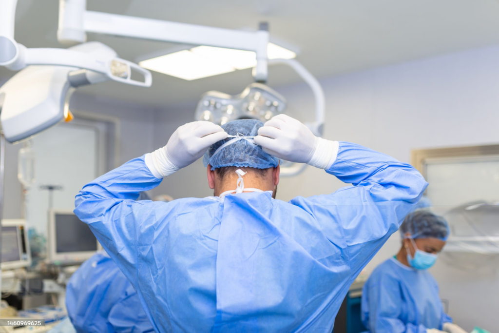 Surgeon in operating room preparing for surgery.