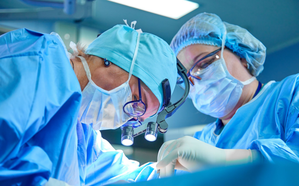 Surgeons performing surgery in an operating theatre.