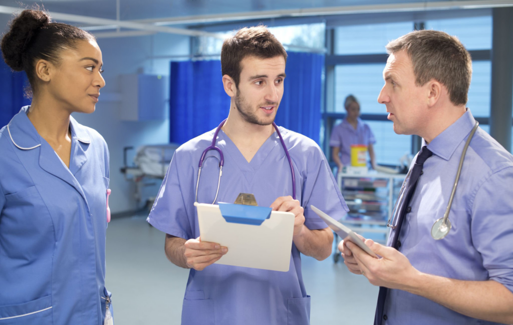 Healthcare professionals discussing patient care in hospital.