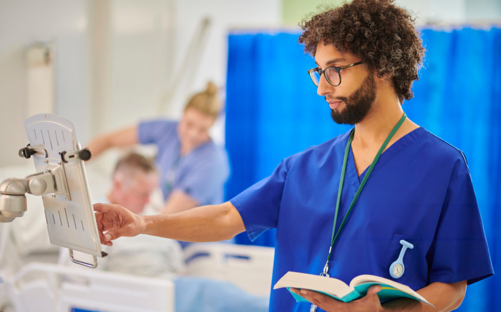 Healthcare professional reading and using medical equipment.