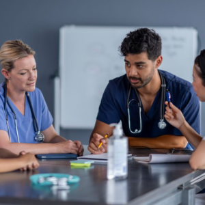 Medical team discussing at a table in hospital.