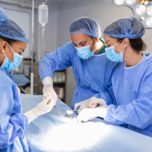 Surgeons performing an operation in operating theatre.