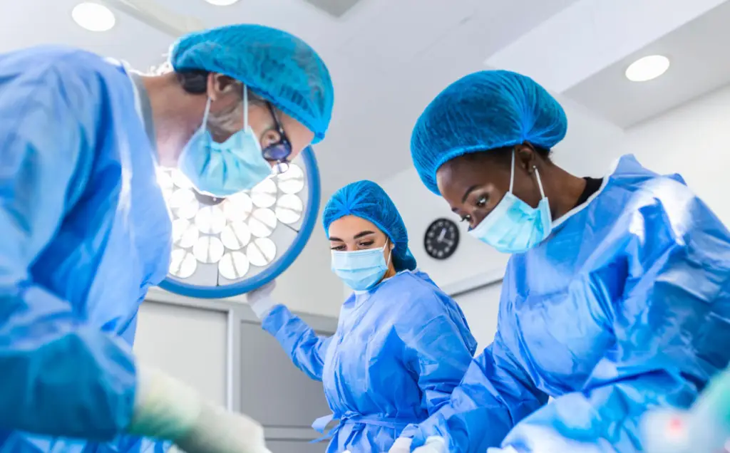 Medical professionals in surgical attire.